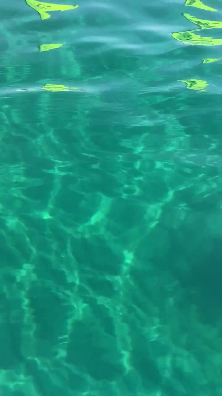 Clear turquoise water with sunlight rippling on the surface