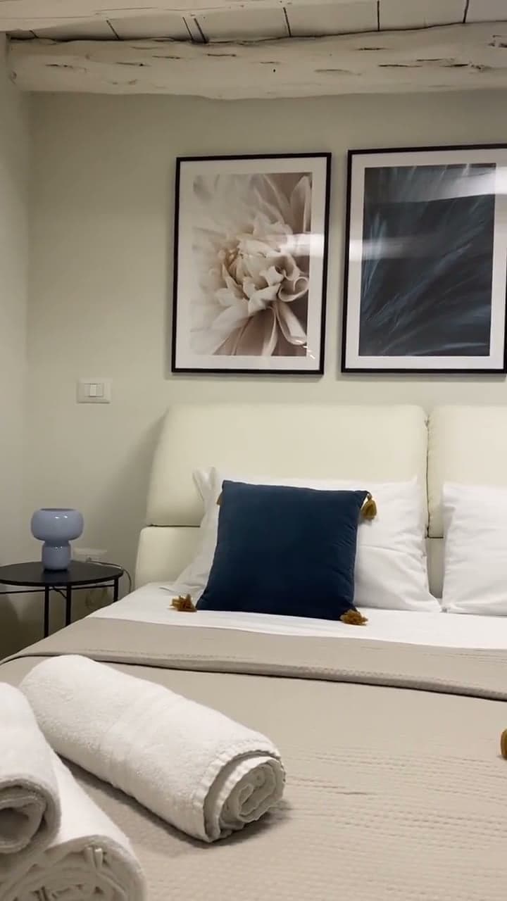 Room tour: a spiral staircase, a bedroom with framed prints, a stone basin, a glass shower and the window