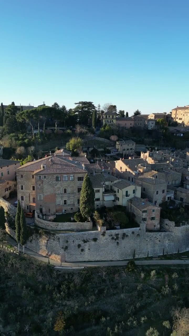 Drone footage slowly flying over the rooftops and walls of Montepulciano